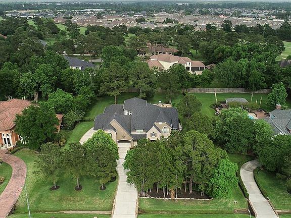 Tremendous privacy with loads of mature trees and extended driveway that circles to the back 4 car garage.