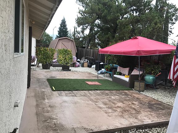 Cottage backyard patio. Now painted chocolate to match main house and all other porches on the grounds. Free from all debris etc shown here. Sliding door from 2nd bedroom entrance to patio ALSO both side yards access the patio which is secluded and priv