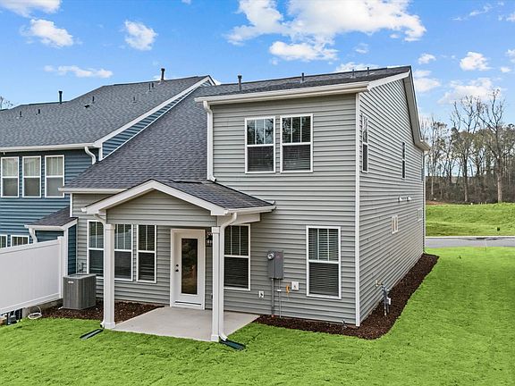 Elegant exterior with a rear covered porch perfect for relaxing or entertaining outdoors