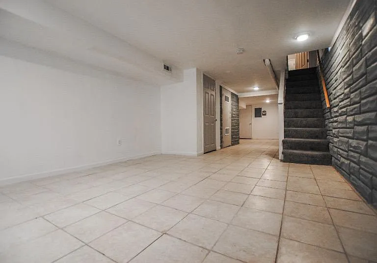 Head downstairs to the finished basement with washer and dryer