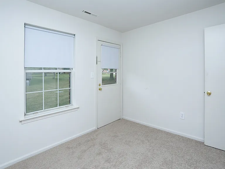 Den Area with rear exterior door.