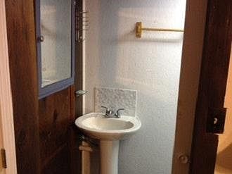BA SINK IS BACK-TO-BACK WITH SHOWER BECAUSE THERE IS A WASHER AND DRYER ON OTHER SIDE OF BATHROOM.