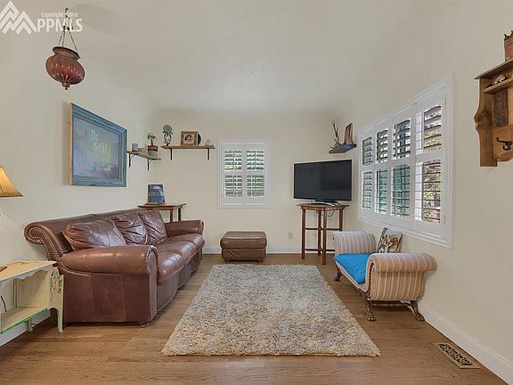 Living room with wood floors and plantation shutters