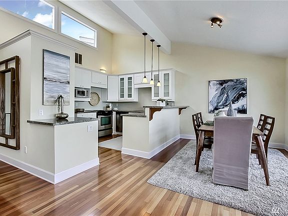Chef's kitchen with eating counter & dining area.