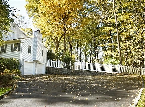 View of the large driveway of the center hall colonial.