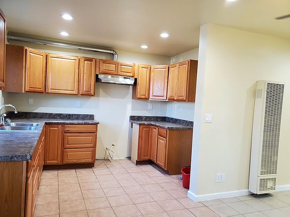 OPEN FLOOR PLAN: LIVING ROOM WITH LARGE CEILING FAN, DINING ROOM AND OPEN KITCHEN A PLUS!