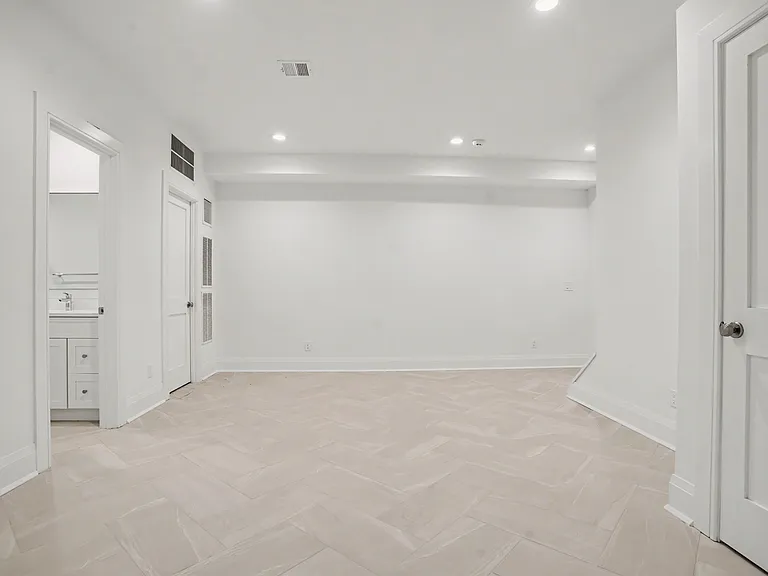 The Lower Level Offers A Multitude of Versatile Spaces for Additional Living, Recreation, or Guest Use.