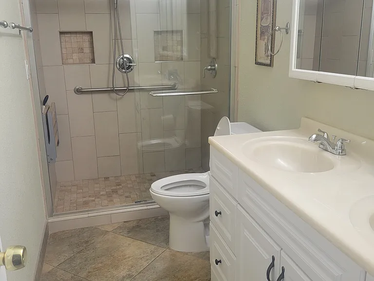 Sinks, toilet and shower in primary bathroom.