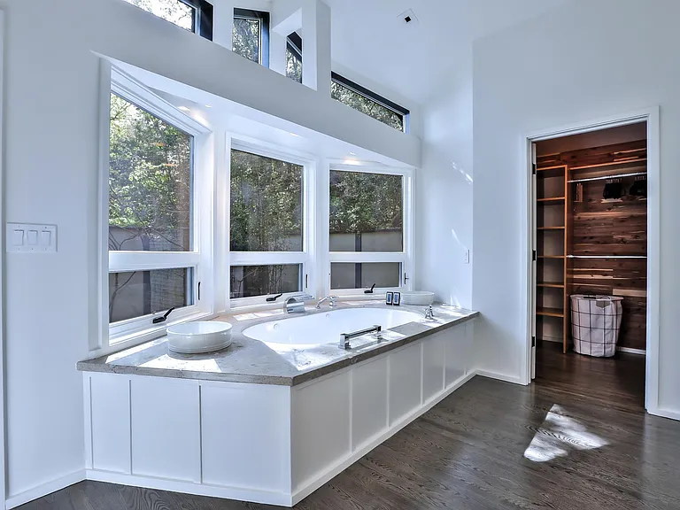 master bath with jetted tub and walk-in cedar closet