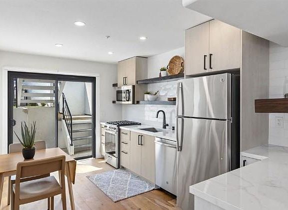 Spacious eat-in kitchen with beautiful stainless steel appliances