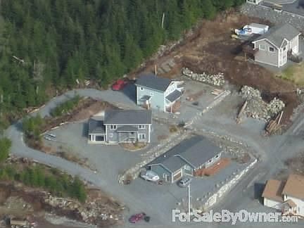 Aerial view of house (red truck parked at light green house)