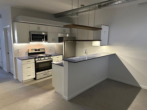 Each unit has an open, contemporary kitchen with brand new stainless steel appliances, quartz countertops, soft-close cabinets, dishwasher and microwave.