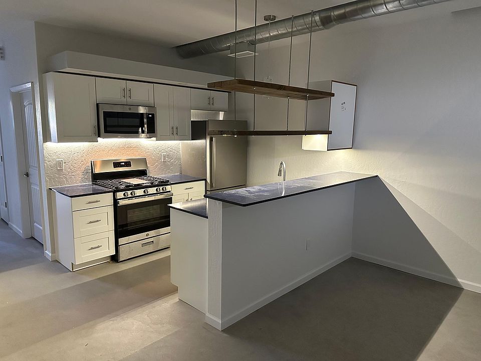 Open, contemporary kitchen with quartz countertops, stainless appliances, dishwasher, soft-close cabinets, under-cabinet lighting. There is a dedicated pantry under the stairs!