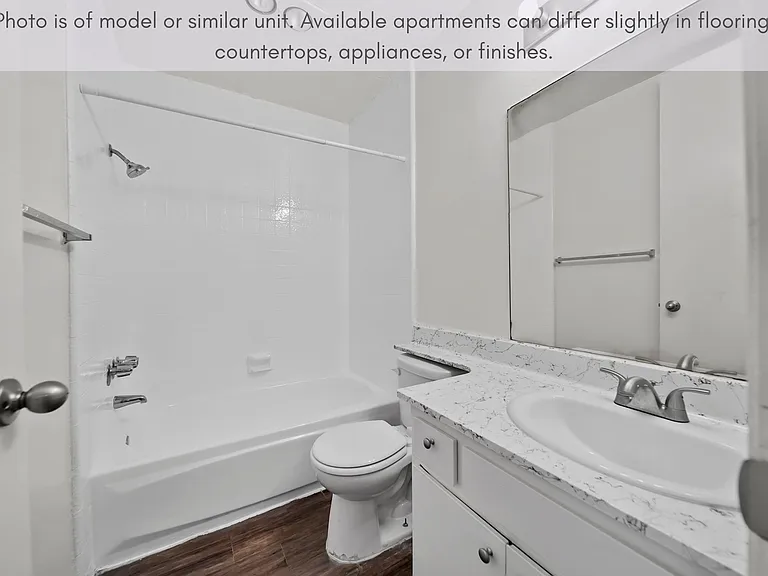 Bright bathroom with a full tub and generous counter space for everyday use.
