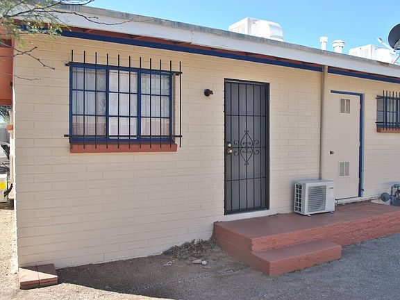 Windows have red brick sills with blue trim.