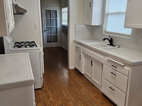 Kitchen with stove and hood.
