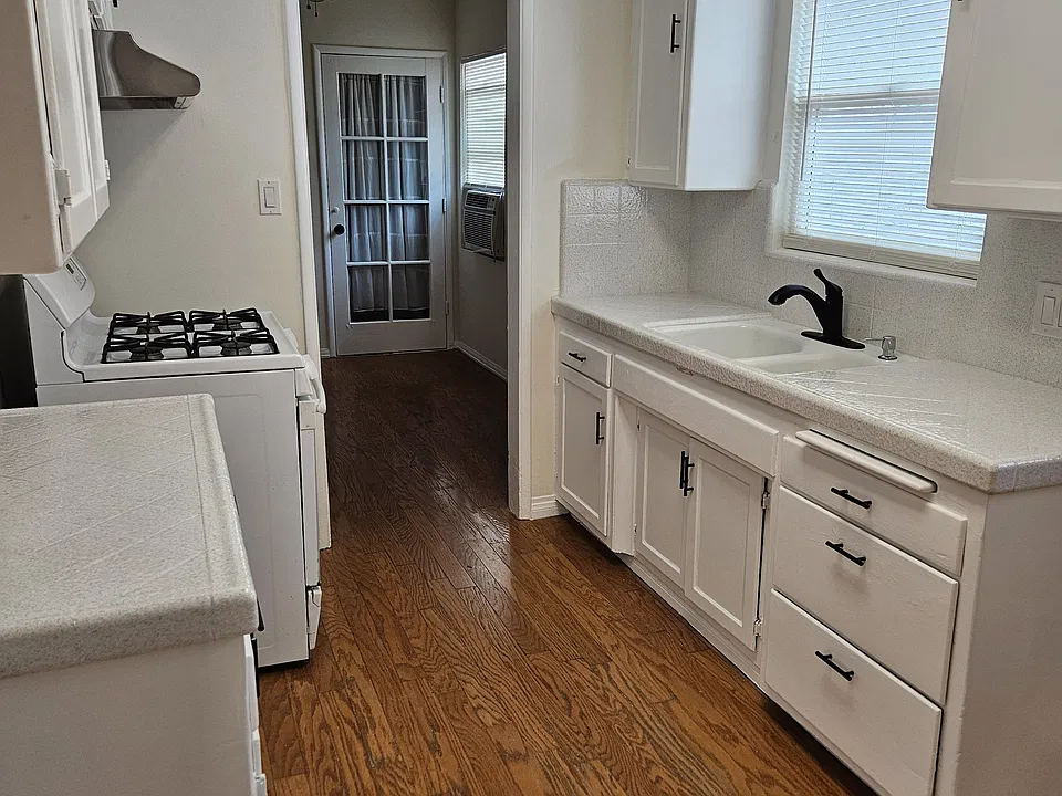 Kitchen with stove and hood.
