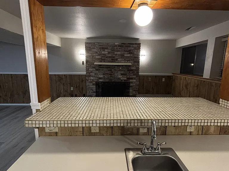 View of the brick fireplace from the wet bar