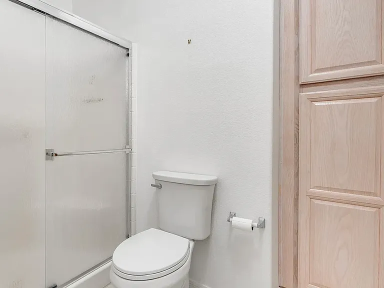 Master bathroom with a shower and storage cabinet.