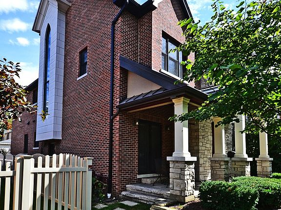 View of North side of home featuring 2 story staircase window.   Let's in lots of light!