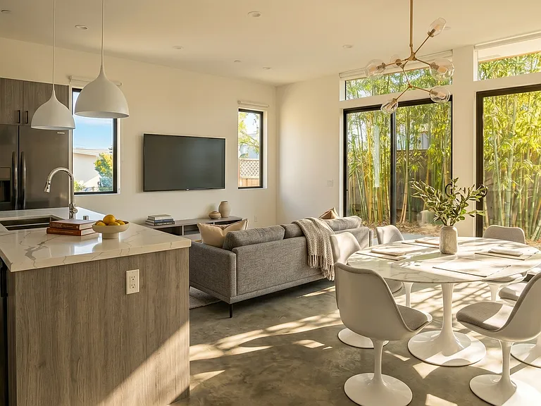 Main living space features high ceilings and wall of glass doors opening to private backyard