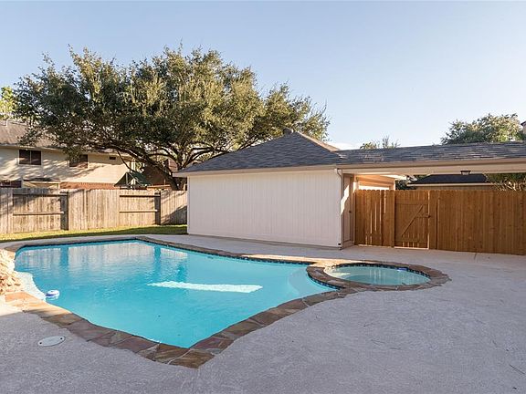 Tall privacy fence along driveway area and plenty of green space behind garage for your furry friends
