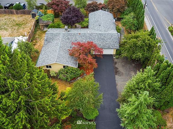 Classic Mid-Century Modern look with long driveway.