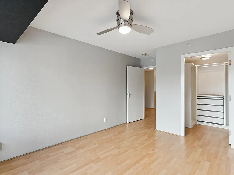 Bedroom 1 with balcony and custom walk-in closet.