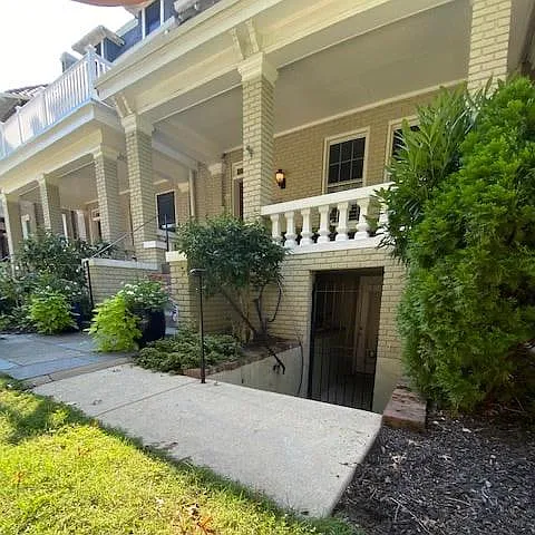 Front entrance with motion detected light, security gate, and outdoor secure bike storage.
