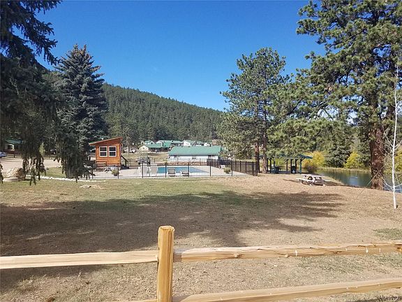 Pool, open space next to pond and covers picnic area.
