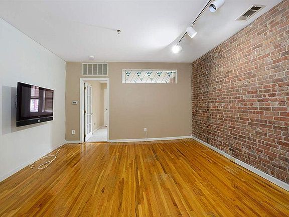 Living Room beautiful brick throughout the apartment