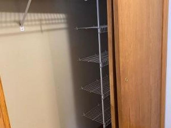 Hall closet directly across from half bath/laundry and a few steps from kitchen.