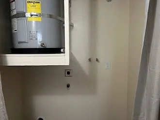 Laundry closet with individual hot water heater and full-size side-by-side (or stackable) hookups