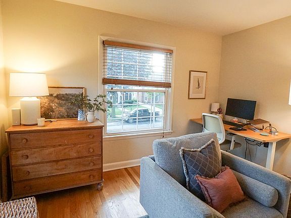 Spacious living room with views of maple-lined 70th Street.