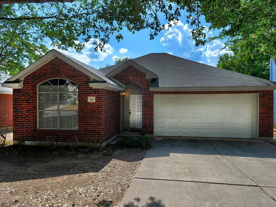 Front of home: red brick with painted trim.
