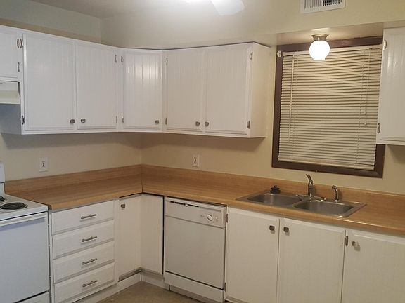 Kitchen offers lots or cabinets and counter space, dishwasher, and stainless steel refrigerator.