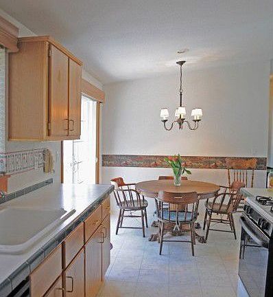 Sparkling kitchen features custom tile accents, and new sliding door to back deck.