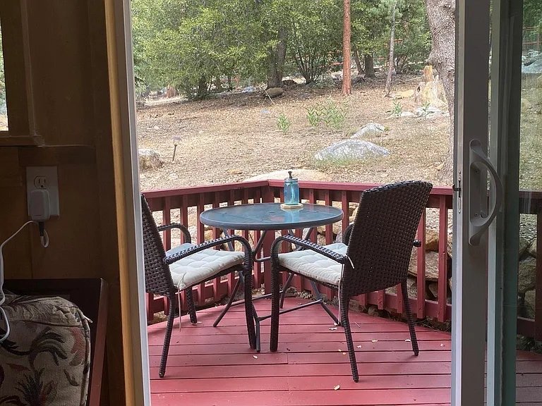 View from sun room to the back patio. There is a Blackstone grill on the back patio as well.