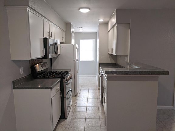 Kitchen opens to dining/living room areas.
Washer/dryer connections area beside rear window which overlooks the huge backyard