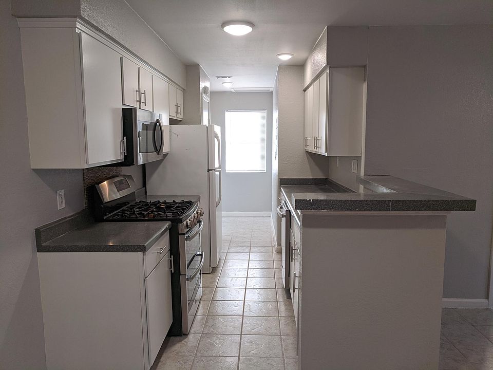 Kitchen opens to dining/living room areas.
Washer/dryer connections area beside rear window which overlooks the huge backyard