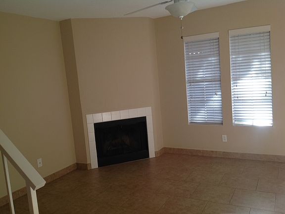 Fire placed family room with faux wood blinds.
