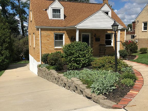 Front of the home showing the long, off street driveway. The driveway easily fits 3 cars end to end and has a 1 car integral garage.