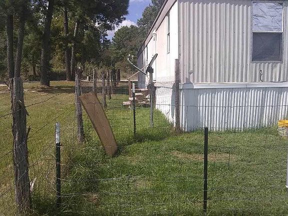 Looking West along the southern side of the trailer. Former tenant had a small dog pen here.