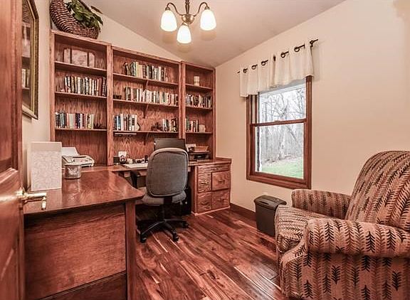 Office off the foyer with custom built in's & hardwood floors