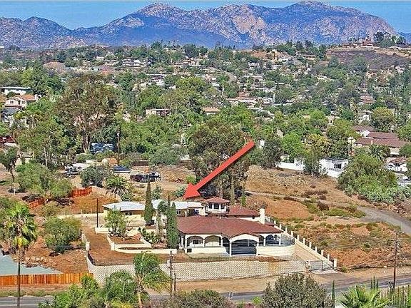 This is the main house showing in the front with the gate. The guest house is in the back pointed at by the red arrow.
