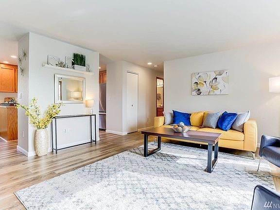 Main bath, two guest rooms and master suite are located down the main hall, to the right of the living room.