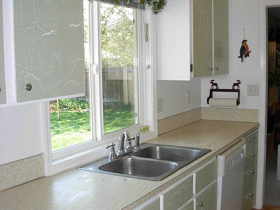 Kitchen overlooks backyard.