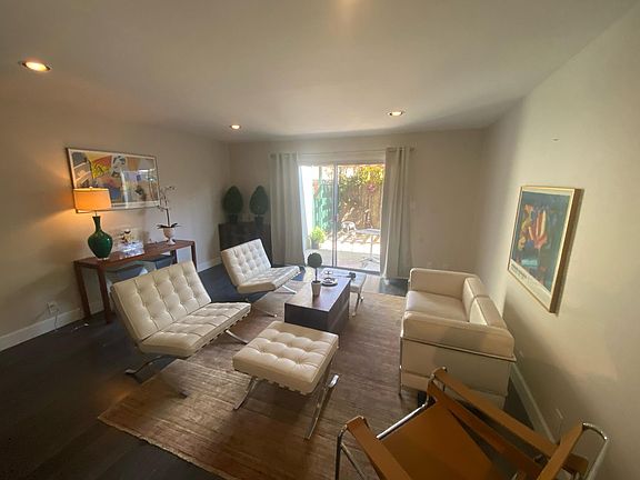 Living room with sliding glass door to private outdoor space.