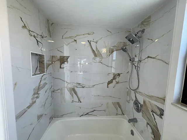 Primary Bathroom, granite countertops, marble tile. Rainshower fixture