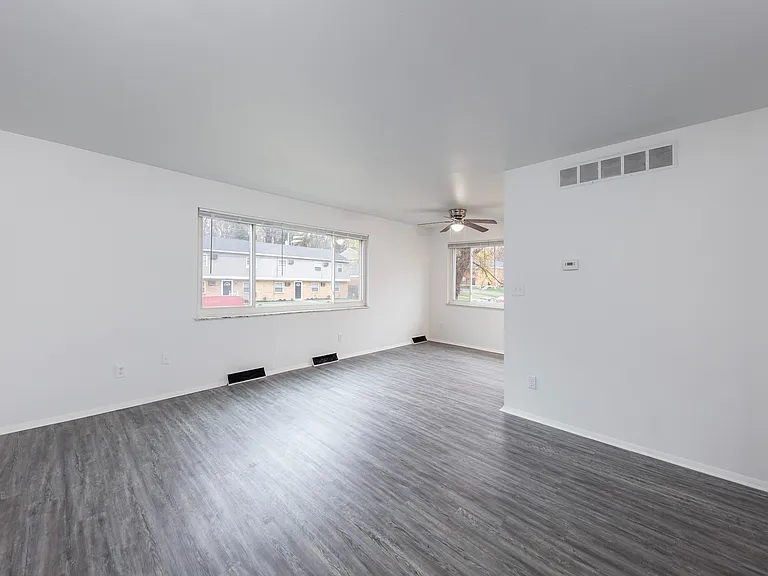 Spacious Living Room with Natural Lighting and Ceiling Fan